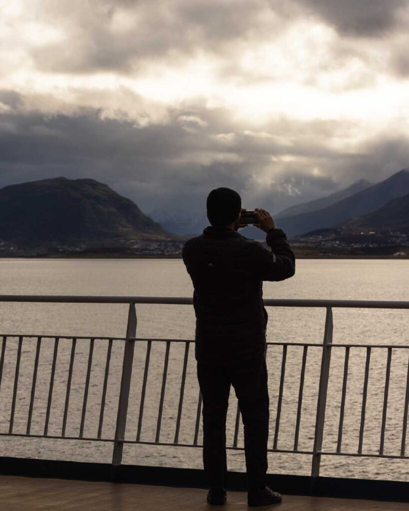 Traveler photographs Ushuaia from the deck, capturing the last mainland views before heading to Antarctica by ship.